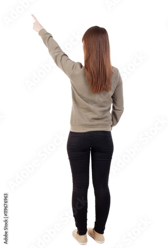 Back view of pointing woman. beautiful girl. Rear view people collection. backside view of person. Isolated over white background.