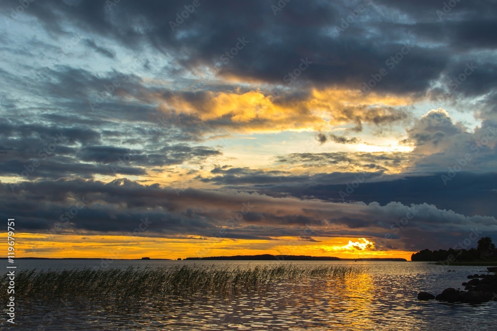 Beautiful tranquil summer sunset on the Onega lake, Karelia, Russia Beautiful tranquil summer sunset on the Onega lake, Karelia, Russia