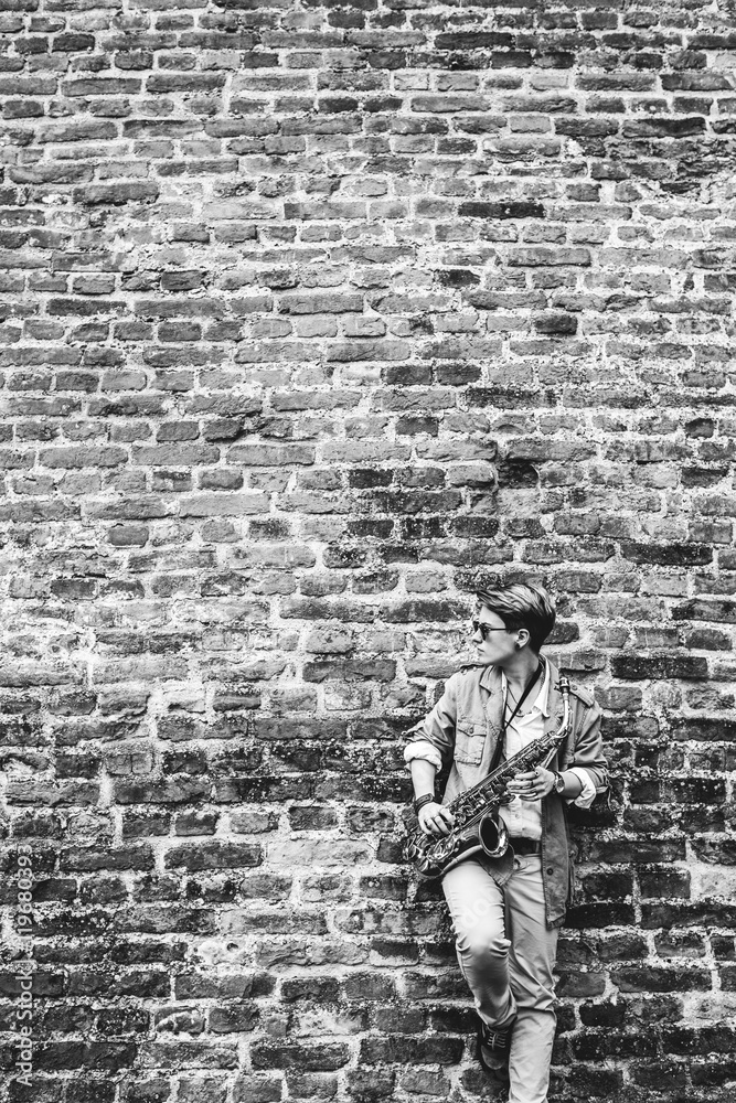 Young woman playing the saxophone, black and white Young woman playing the saxophone, black and white