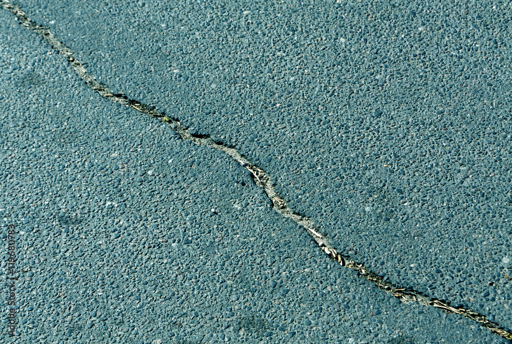 Obraz premium Cracked color asphalt surface.