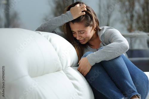 Sad girl crying alone at home