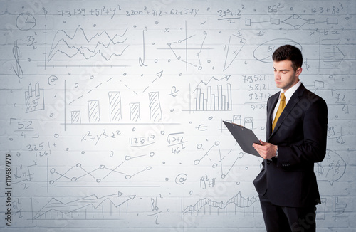 Salesman standing with drawn graph charts