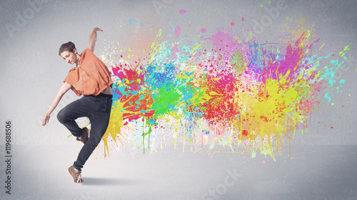 Young colorful street dancer with paint splash