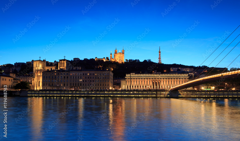 Night view over the Saone river to the Fourviere cathedral in Lyon city.