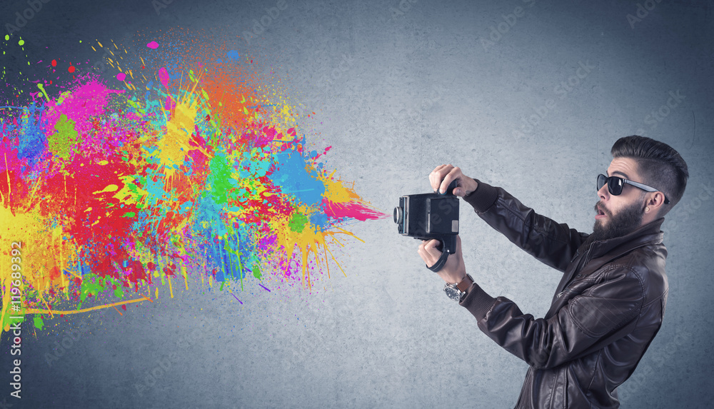 Hipster guy with camera and paint splash Hipster guy with camera and paint splash