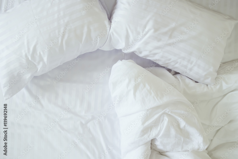 Top view of messy bedding sheets and pillows. Top view of messy bedding sheets and pillows.