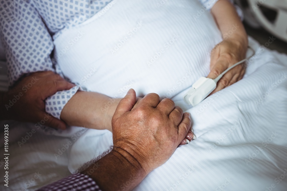 Senior man holding hands of senior woman Senior man holding hands of senior woman