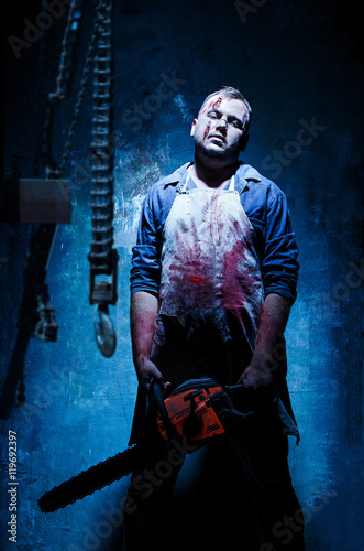Bloody Halloween theme  crazy killer as butcher with electric saw