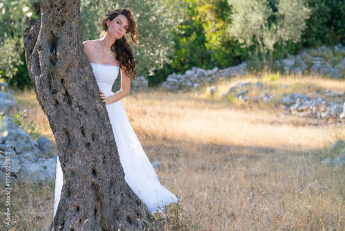 Attractive young woman enjoying her time outside in olive trees.