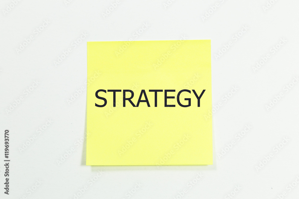 Strategy word written on yellow sticky notes. isolated on white Strategy word written on yellow sticky notes. isolated on white