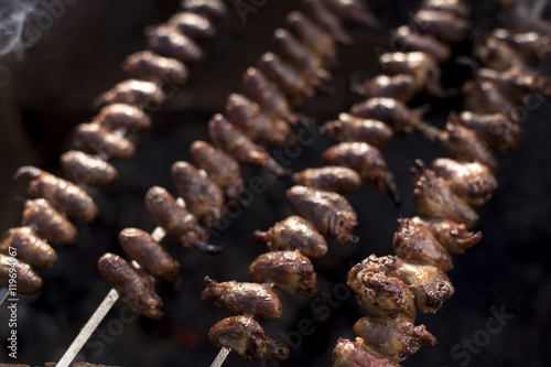 Churrasco, traditional Brazilian barbecue, chicken hearts grilled kebabs.