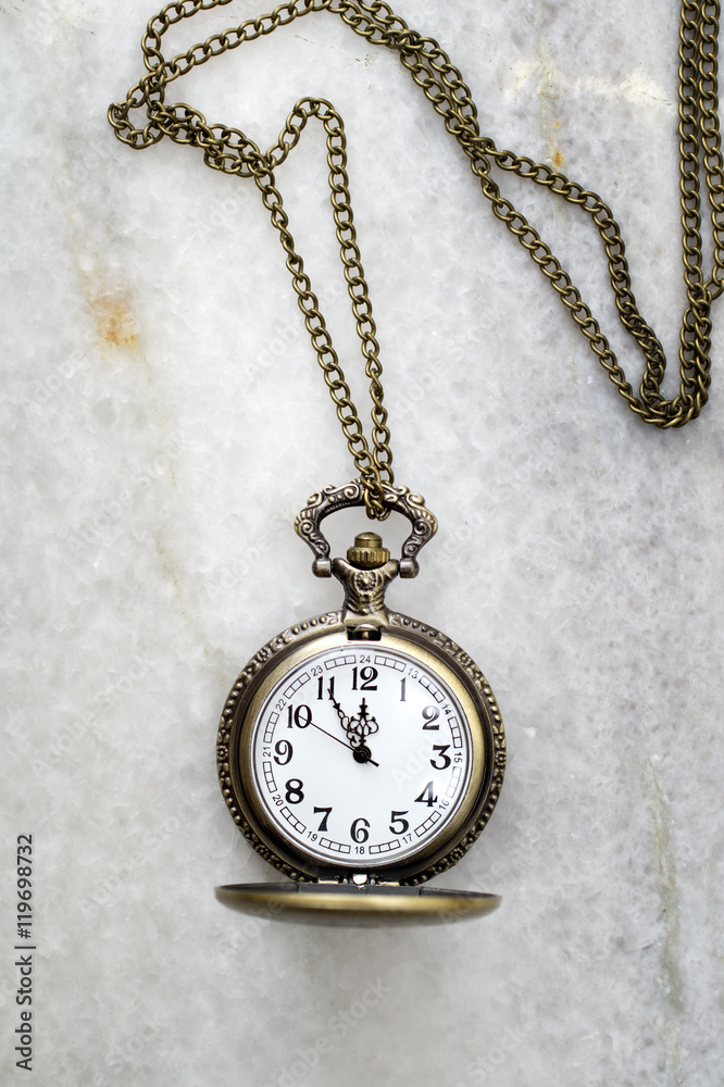 Pocket watch with chain on marble. Pocket watch with chain on marble.