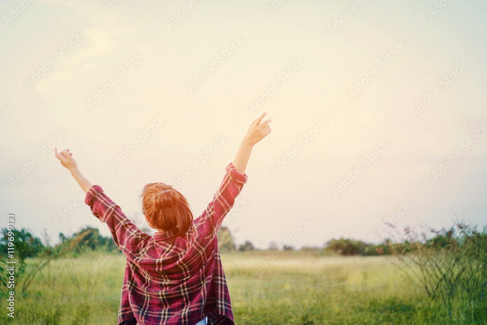 Freedom Young woman stretching her arms into the sky enjoy of ti Freedom Young woman stretching her arms into the sky enjoy of ti