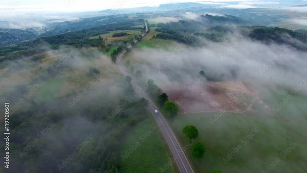 Aerial View Of Car On Foggy Rural Road Aerial View Of Car On Foggy Rural Road