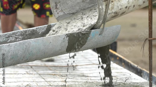 Non identify Construction workers pour concrete mix from cement mixer.Slow motion 120 fps.