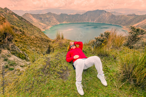 Woman Lying On The Ground Near Edge Of Quilotoa Lake