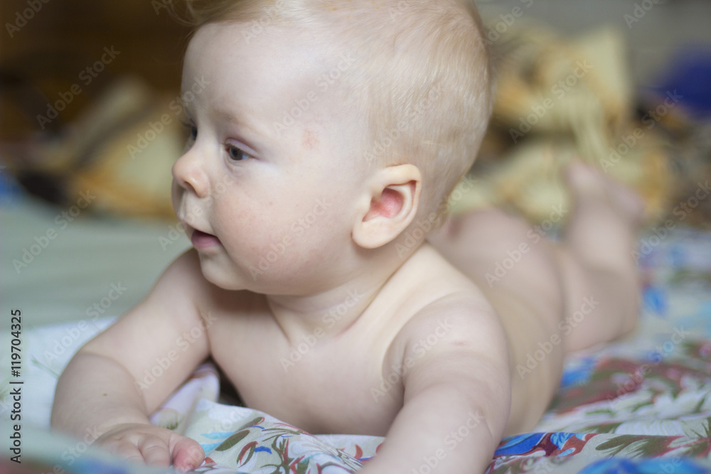Cute baby lying on the bed, portrait, soft focus