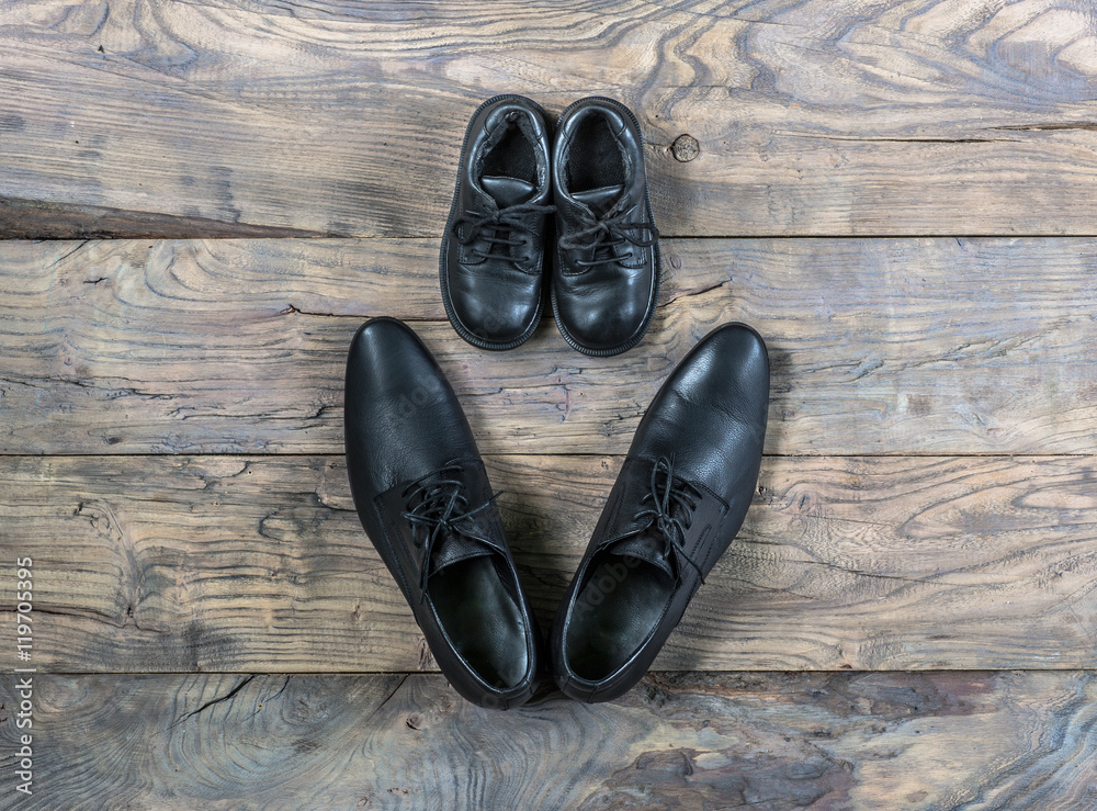 Men's and women's shoes on the old wooden floor Men's and women's shoes on the old wooden floor