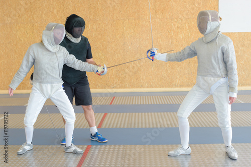 three fencers on a practice