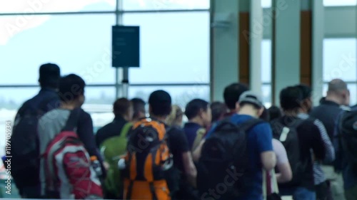 OUt of focus group of passengers boarding plane