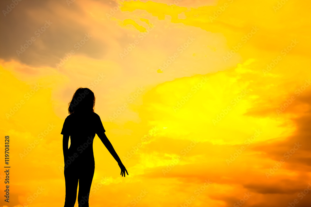 Happy young woman silhouette with twilight sunset.