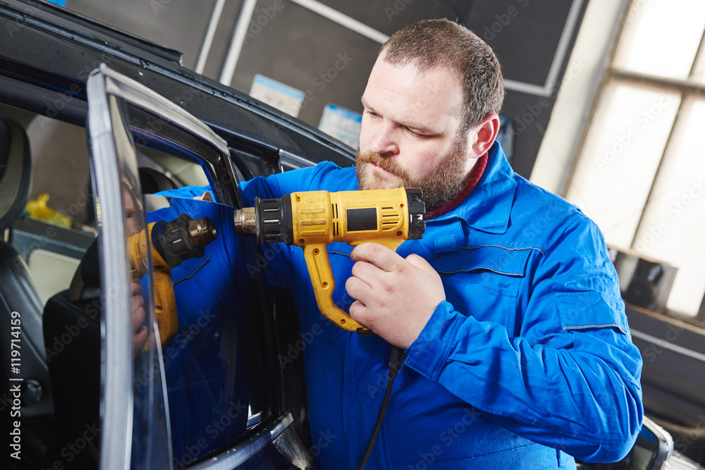 car tinting. Automobile mechanic technician applying foil car tinting. Automobile mechanic technician applying foil