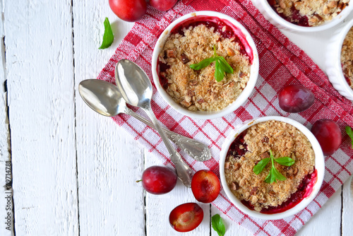 Wallpaper Mural Oat crumble with plums, spices and honey on a light background Torontodigital.ca
