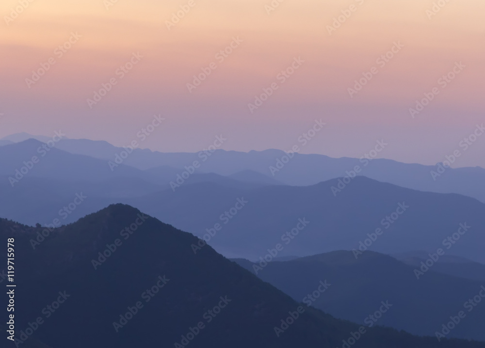 Silhouettes of the mountain hills after sunset. mountain cascade