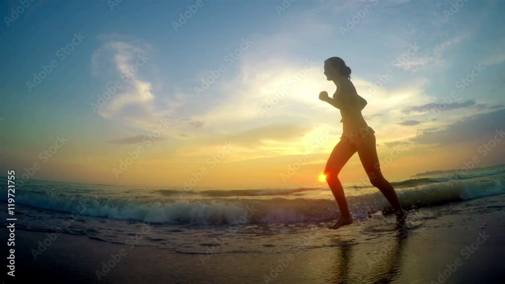 Girl model running jogging barefoot at beach Girl model running jogging barefoot at beach