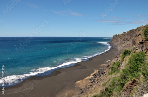 Fishing boats under cliff