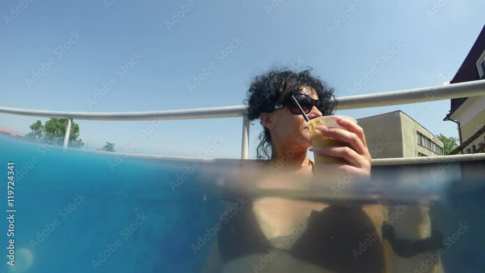 Pretty female model drinks caffee in thermal pool
