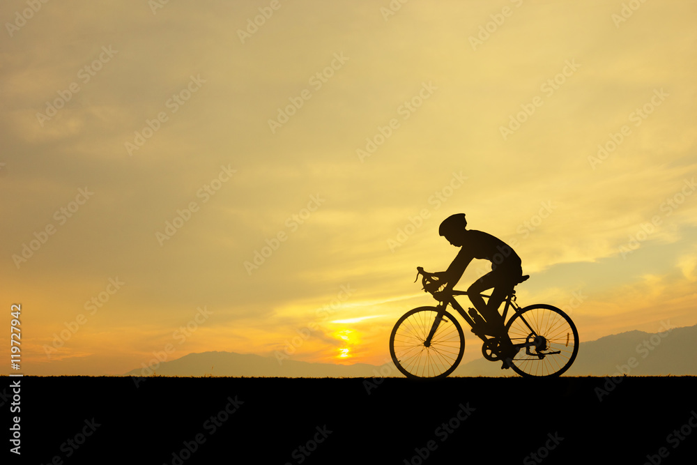 Silhouette of man and him cycling on the lawn in sunset time. Silhouette of man and him cycling on the lawn in sunset time.