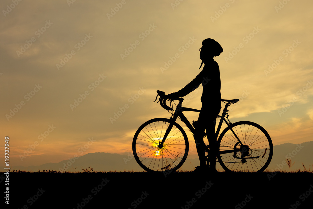 Silhouette of man, him standing with bicycle and looking at the sky in sunset time. Silhouette of man, him standing with bicycle and looking at the sky in sunset time.