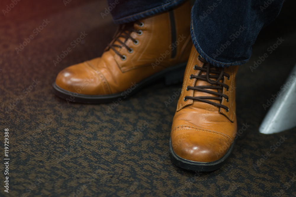 fashion man's in blue jeans and brown boots, vintage soft focus
