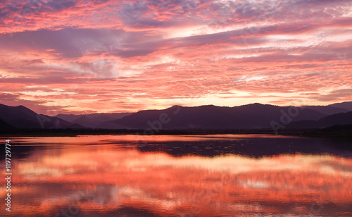 Beautiful of orange sunset behind mountains in Thailand