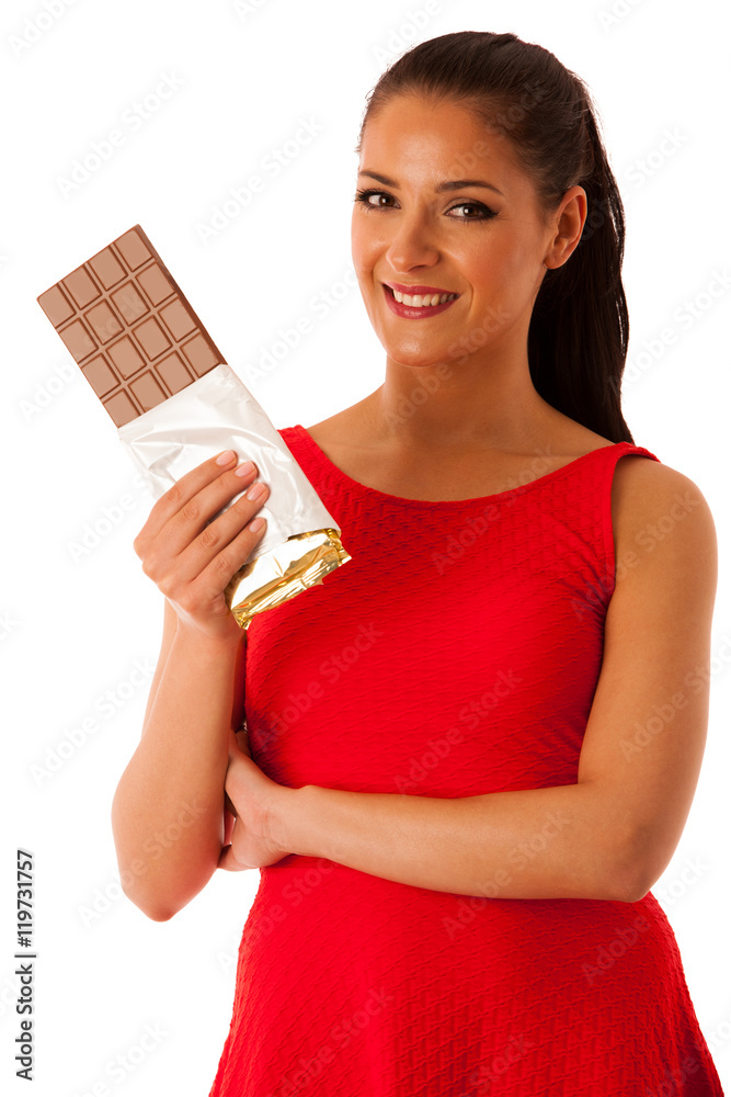 Beautiful young woman eats chocolate isolated over white backgro Beautiful young woman eats chocolate isolated over white backgro