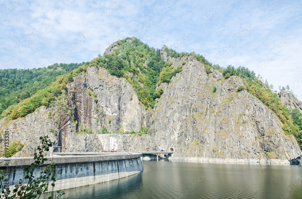 The barrage, dam Vidraru on the river Arges, green hills and rocks