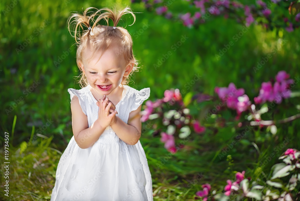 adorable little girl laughing and playing their hands adorable little girl laughing and playing their hands