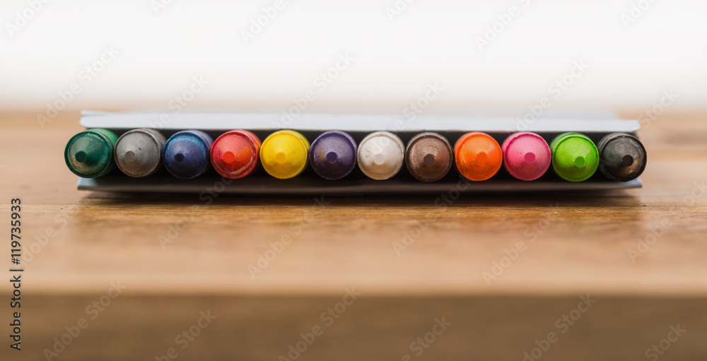 The colorful crayon on the wooden background The colorful crayon on the wooden background