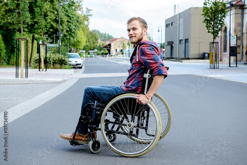 Bild auf Leinwand disabled man in wheelchair on road