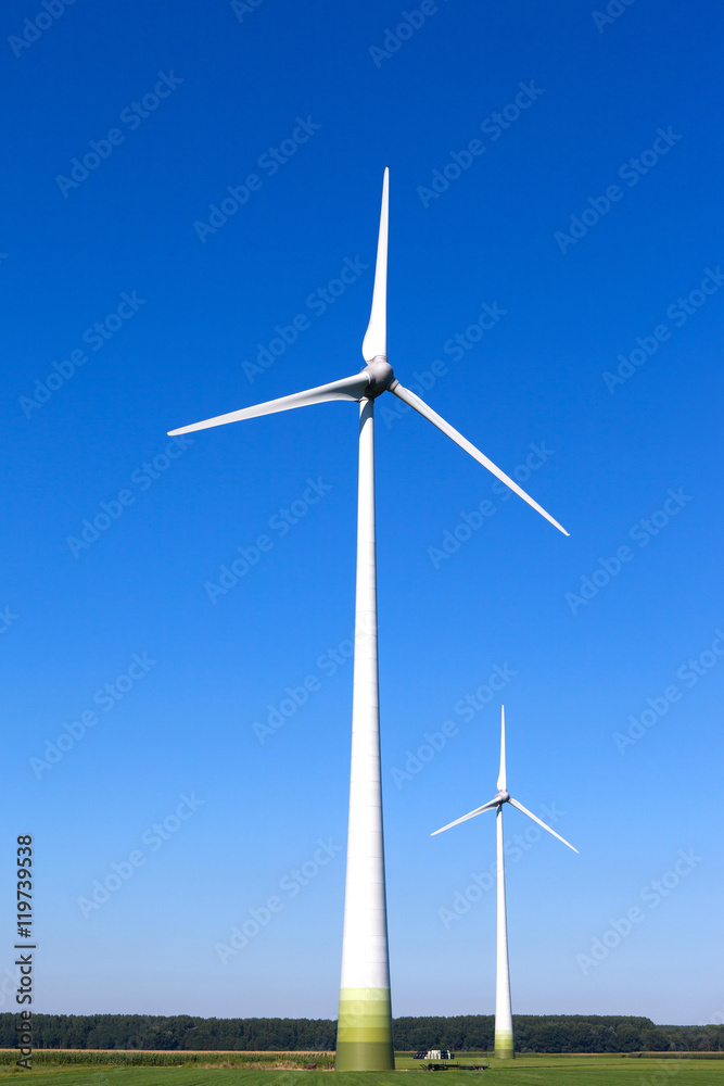 Wind turbine spinning with in a green countryside environment