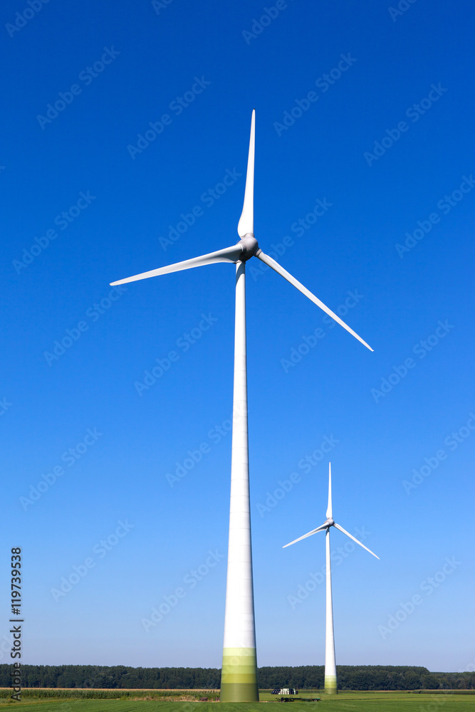 Wind turbine spinning with in a green countryside environment Wind turbine spinning with in a green countryside environment
