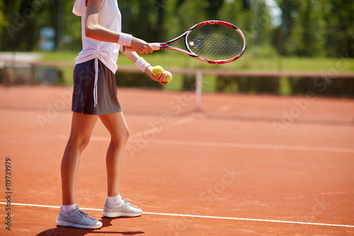 Tennis player serving tennis balls © luckybusiness