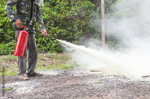 A man demonstrating how to use a fire extinguisher