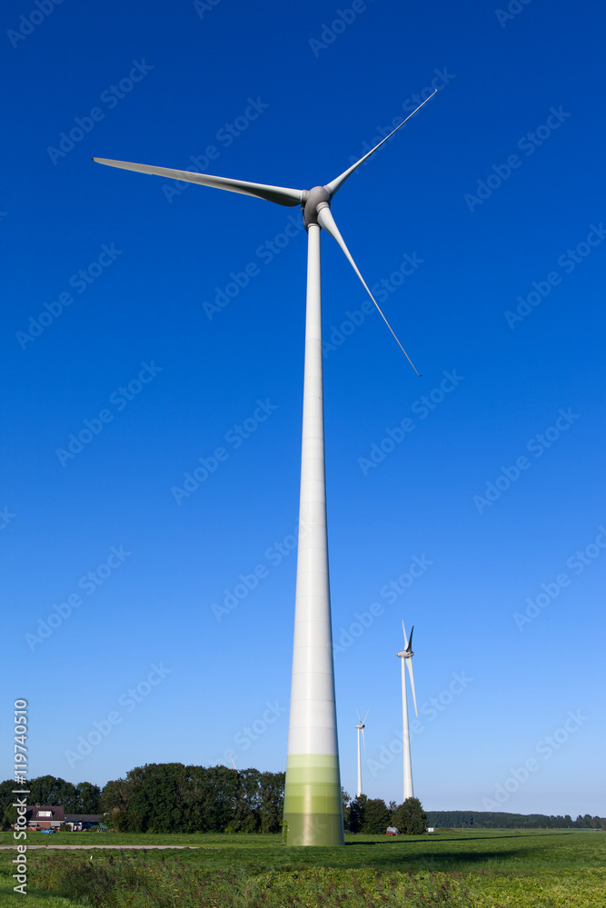 Wind turbine spinning with in a green countryside environment Wind turbine spinning with in a green countryside environment