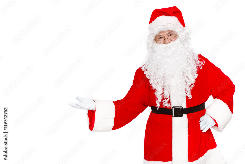 Naklejka premium Copy space in hand of Santa. Happy Santa Claus standing on white background