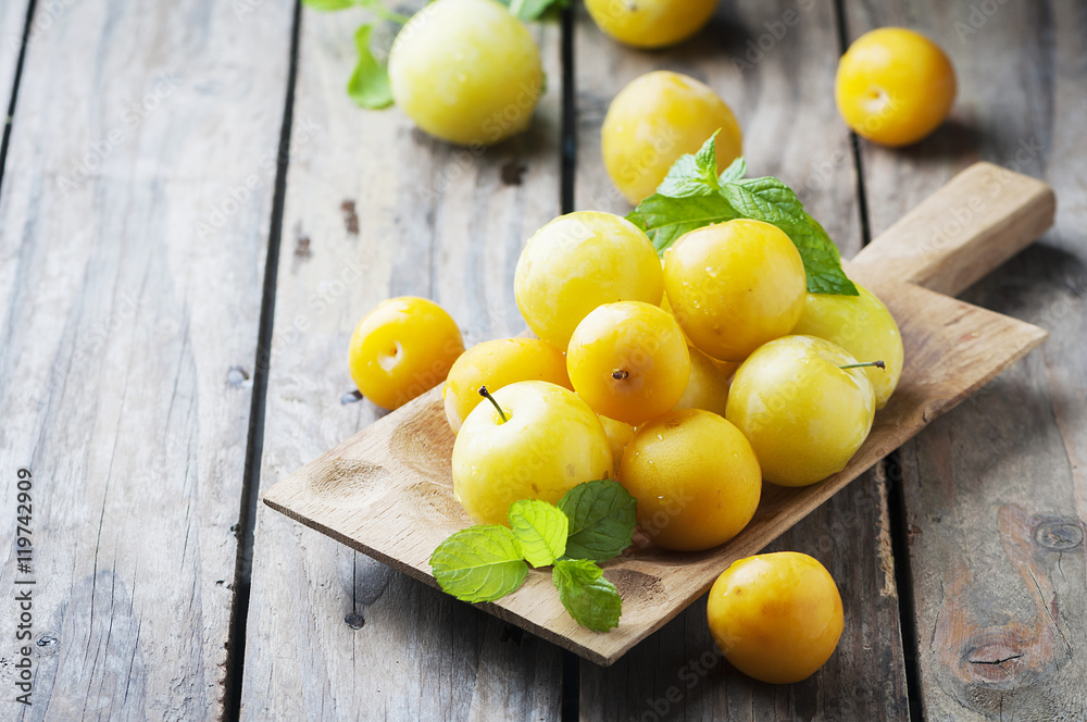Summer sweet yellow plums on the wooden table Summer sweet yellow plums on the wooden table