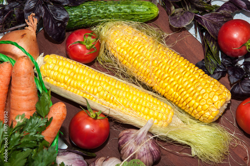 Fresh vegetables and greens on the kitchen table