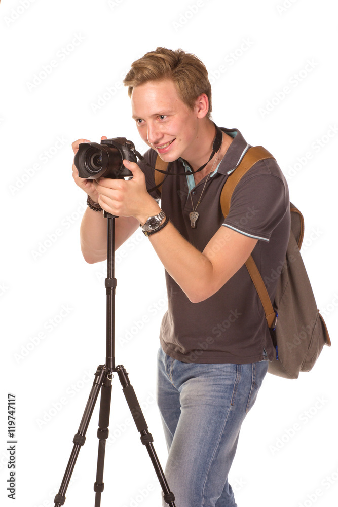 Young man with camera on tripod