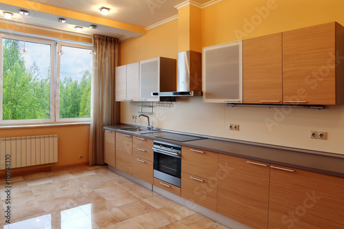 Luxury kitchen interior with orange walls , stone floor and fore